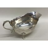 An Edwardian silver sauce boat with card cut rim.