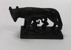 A small bronze figure of Romulus and Remus with the She-Wolf on square cast