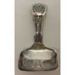 A silver honeysuckle pattern caddy spoon with squa