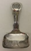 A silver honeysuckle pattern caddy spoon with squa