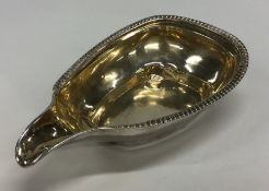 A Georgian silver gilt pap boat with gadroon rim.