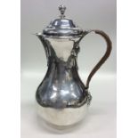 A good George I silver water jug, the handle decor