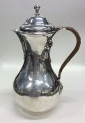 A good George I silver water jug, the handle decor