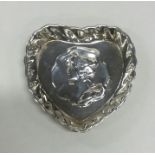 A small silver heart shaped pin dish. Birmingham.