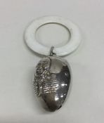 A silver Humpty Dumpty rattle with loop top. Appro
