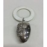 A silver Humpty Dumpty rattle with loop top. Appro