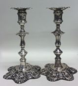 A good pair of George II cast silver candlesticks