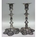 A good pair of George II cast silver candlesticks