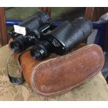A pair of leather cased binoculars.