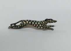 An unusual opal brooch in the form of a greyhound.