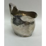 EXETER: A Georgian silver cream jug with bright cu