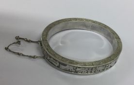 An unusual silver hinged bracelet decorated with f