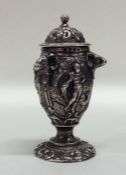 A heavy Victorian cast silver pepper decorated wit