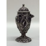 A heavy Victorian cast silver pepper decorated wit