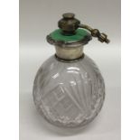 A silver and enamel atomiser with cut glass body.
