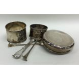 A collection of silver napkin rings, teaspoons etc