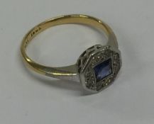 A stylish sapphire and diamond cluster ring in 18