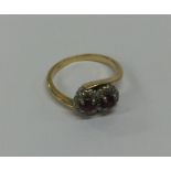 An 18 carat gold ruby and diamond cluster ring in