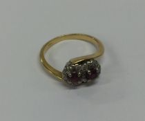 An 18 carat gold ruby and diamond cluster ring in