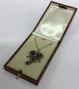 An amethyst and rose diamond pendant on fine link