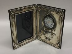 A large silver folding photograph frame / clock de