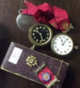 A silver Masonic badge together with some watches.