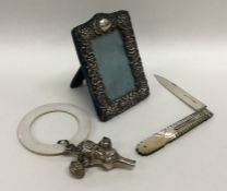 A small embossed silver picture frame together wit