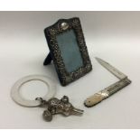 A small embossed silver picture frame together wit