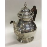 A heavy Georgian style silver teapot decorated wit