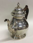 A heavy Georgian style silver teapot decorated wit