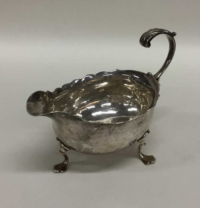 A Georgian miniature silver sauce boat with card c