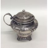 A Victorian embossed silver mustard decorated with
