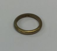 A 9 carat plain wedding band. Approx. 3 grams. Est