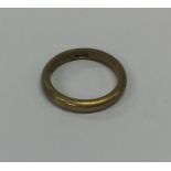 A 9 carat plain wedding band. Approx. 3 grams. Est