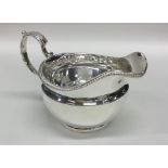 A good circular Georgian silver cream jug with gad