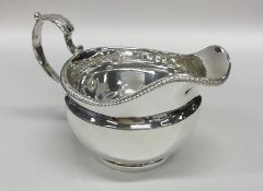 A good circular Georgian silver cream jug with gad