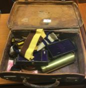 An old leather case containing whistles, shell cas
