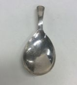 A Georgian silver caddy spoon with fluted bowl. Ap
