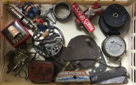 A box containing whistles, car badges, toys etc.