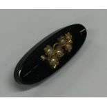 An onyx, pearl and gold boat shaped bar brooch wit
