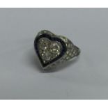 A large sapphire and diamond heart shaped ring in