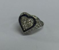 A large sapphire and diamond heart shaped ring in