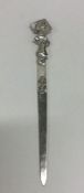 A stylish silver letter opener with textured handl