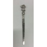 A stylish silver letter opener with textured handl