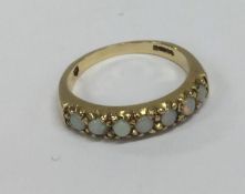 A 9 carat opal mounted half eternity ring. Approx.