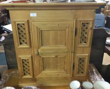 A stripped pine hanging cupboard.