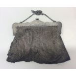 A silver mesh purse on suspension chain. Approx. 3