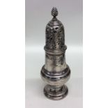 A tall Georgian baluster shaped silver caster with