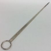 A massive silver tapering meat skewer with ring th