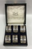 A boxed set of six silver pierced napkin rings. Bi